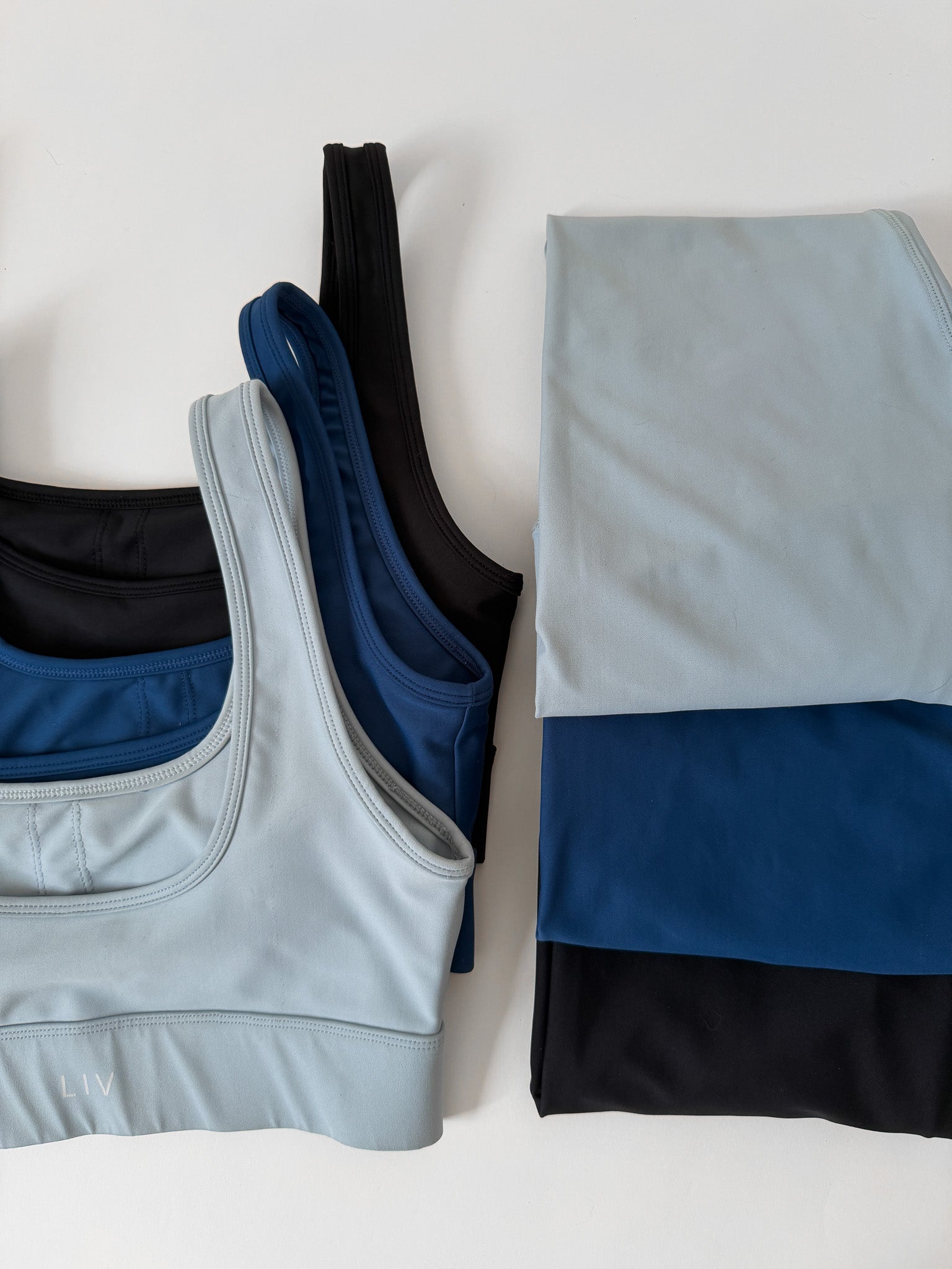 black, light blue and black sportsbras and leggings 